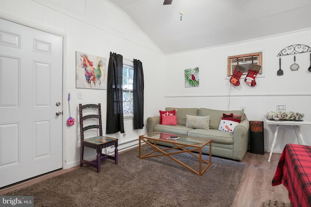 living room featuring hardwood / wood-style floors, vaulted ceiling, and a baseboard heating unit