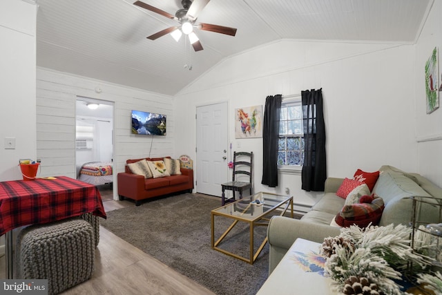 living room featuring wood walls, ceiling fan, wood-type flooring, and lofted ceiling