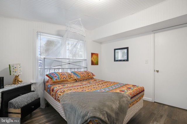 bedroom with dark hardwood / wood-style flooring