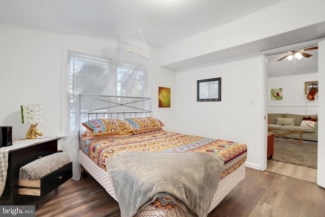 bedroom with ceiling fan and dark hardwood / wood-style floors