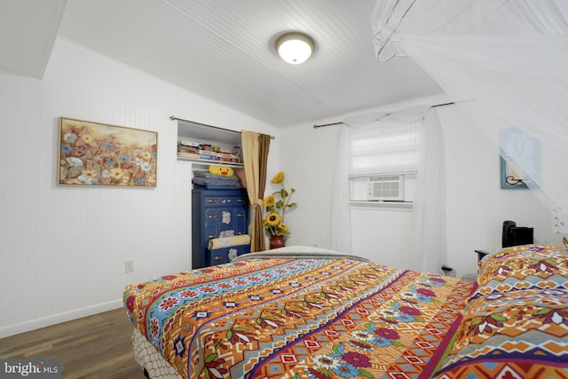 bedroom featuring cooling unit and dark wood-type flooring