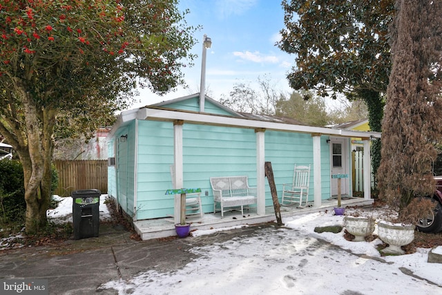 view of snow covered rear of property