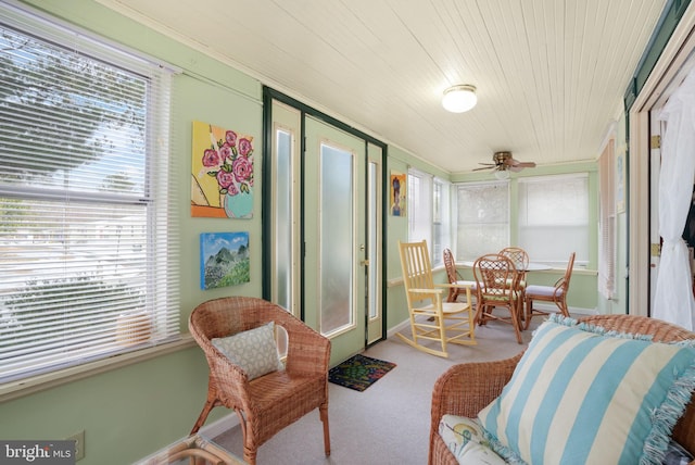 sunroom / solarium featuring ceiling fan and wooden ceiling