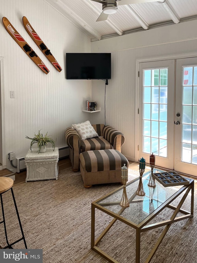 living room featuring ceiling fan, wood walls, lofted ceiling, and french doors