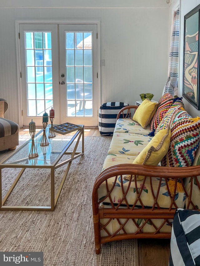 living room featuring french doors, hardwood / wood-style floors, and plenty of natural light