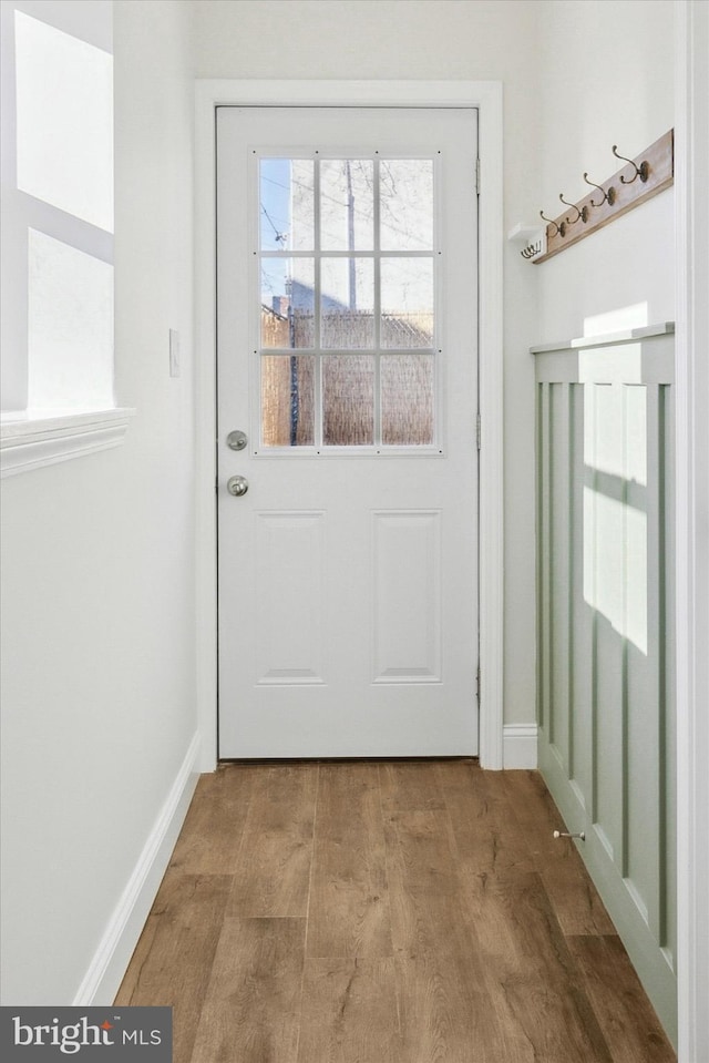 doorway to outside with wood-type flooring