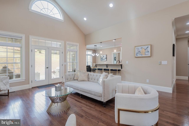 living room with dark wood-type flooring, french doors, high vaulted ceiling, and a healthy amount of sunlight