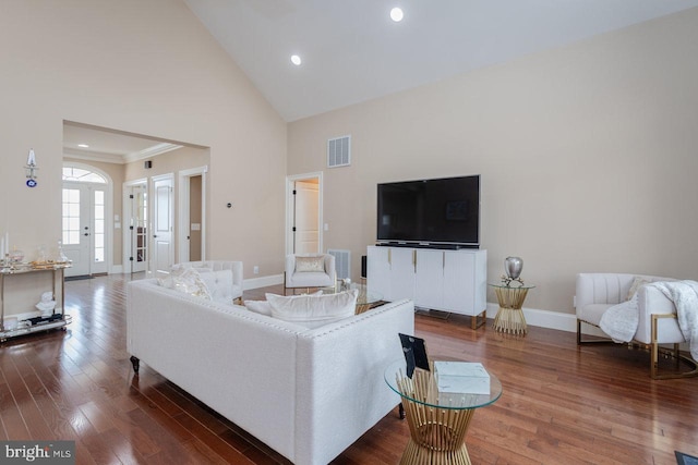 living room with dark hardwood / wood-style flooring, french doors, and high vaulted ceiling