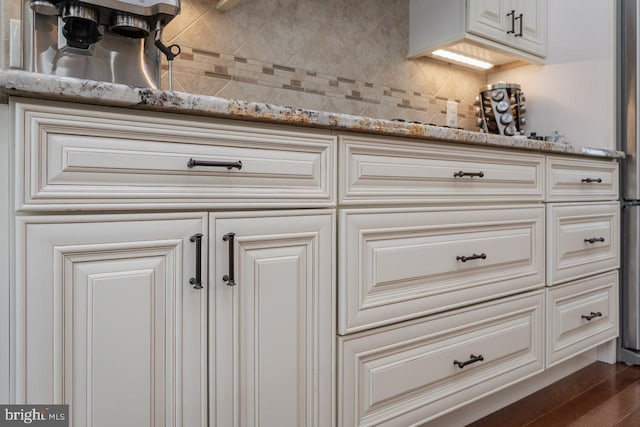 details featuring hardwood / wood-style flooring and tasteful backsplash