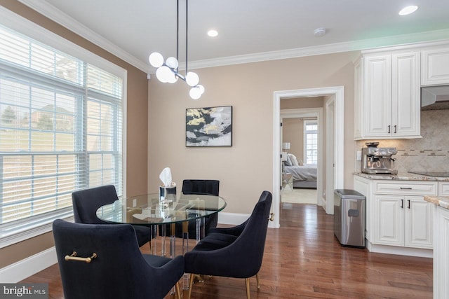 dining room featuring dark wood-type flooring and ornamental molding