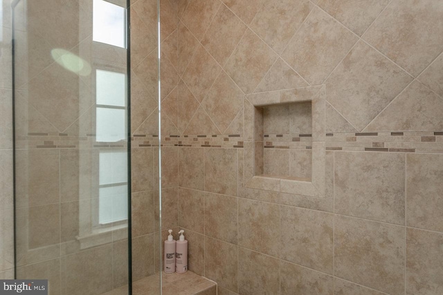 bathroom with a tile shower