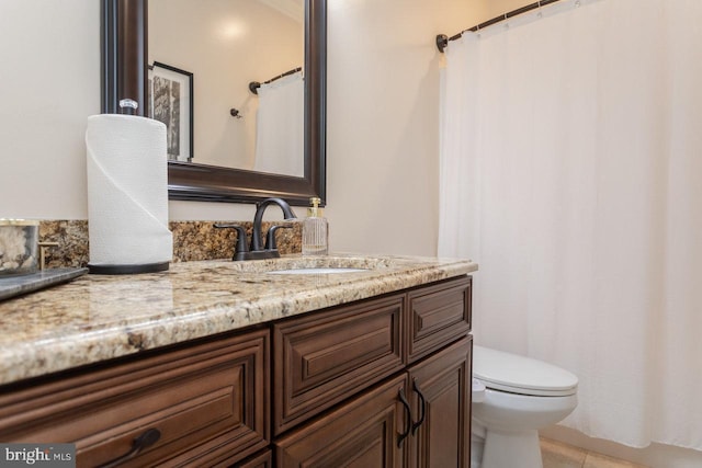 bathroom with tile patterned floors, vanity, and toilet