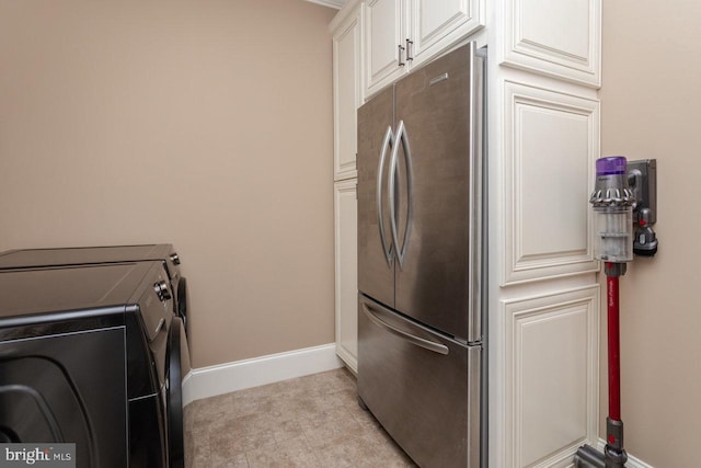 laundry area featuring cabinets and independent washer and dryer