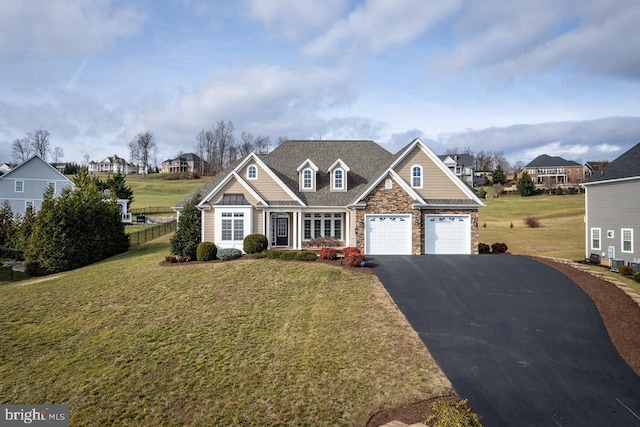 craftsman-style house featuring a garage and a front lawn