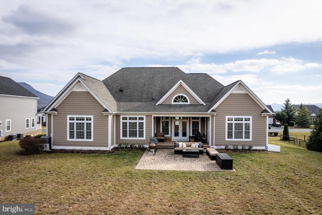 back of property featuring an outdoor hangout area, a patio area, and a lawn