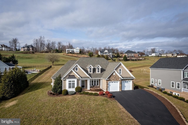 view of front of property with a garage and a front lawn