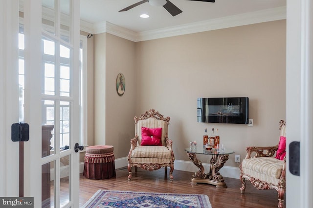 sitting room with hardwood / wood-style floors, french doors, ceiling fan, and crown molding