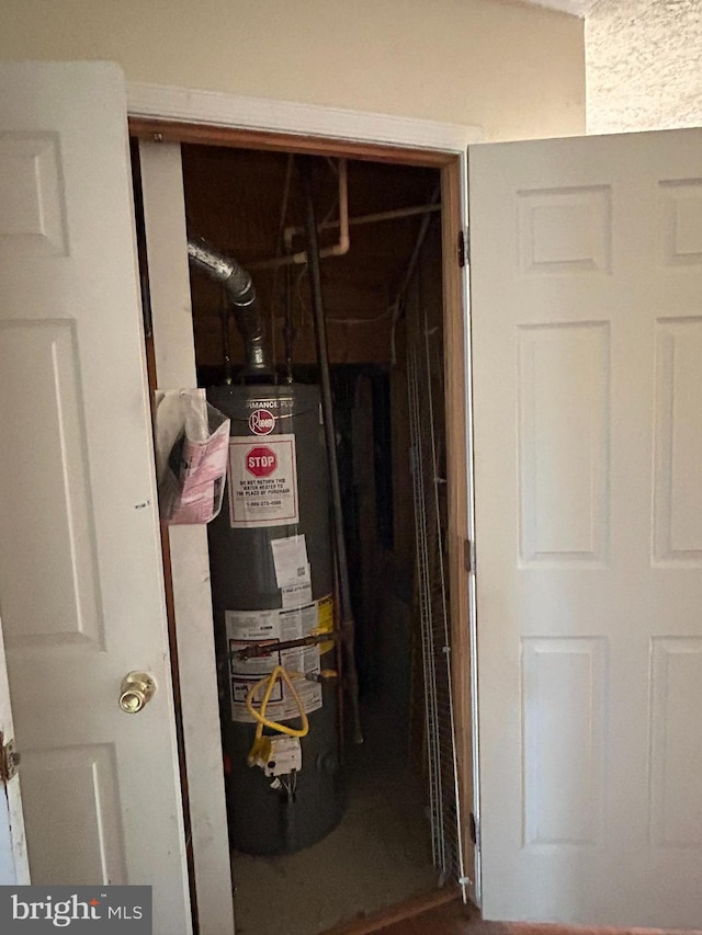 utility room featuring water heater