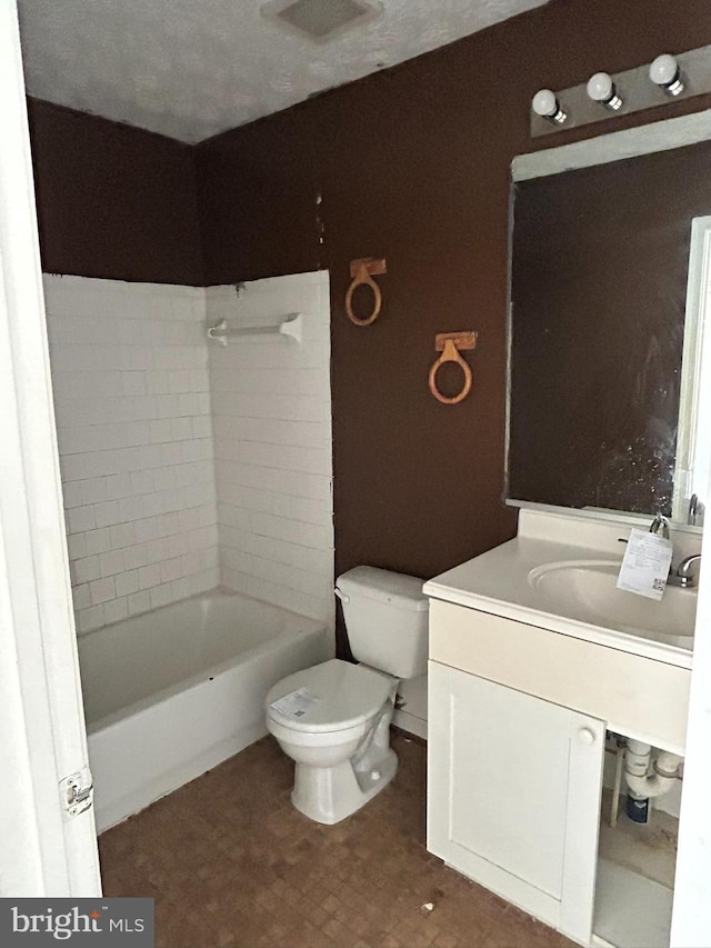 bathroom with a washtub, toilet, a textured ceiling, and vanity