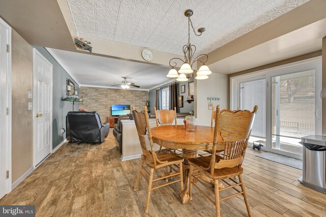 dining room with light wood-type flooring and ceiling fan with notable chandelier