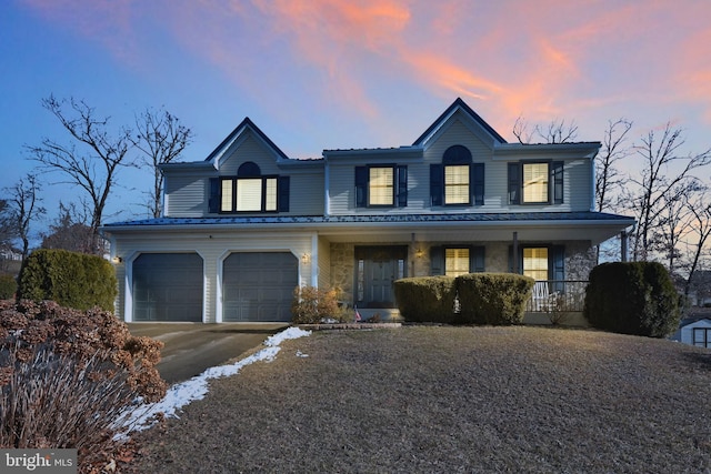 view of front facade featuring a porch and a garage