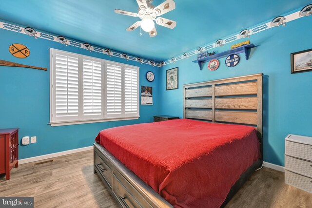 bedroom with hardwood / wood-style flooring and ceiling fan