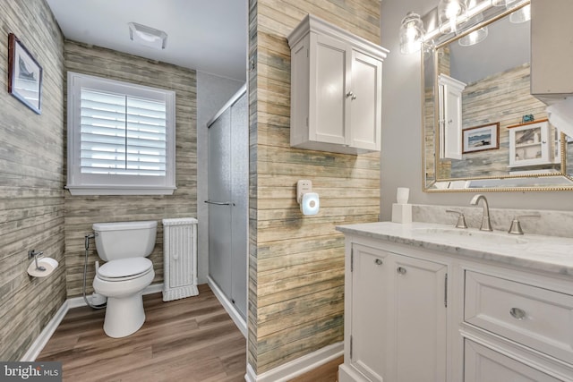 bathroom with hardwood / wood-style floors, vanity, and toilet