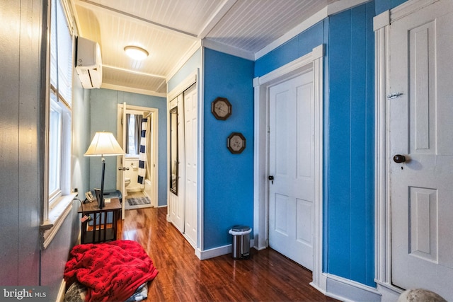 entrance foyer with a wall mounted AC, crown molding, and dark wood-type flooring