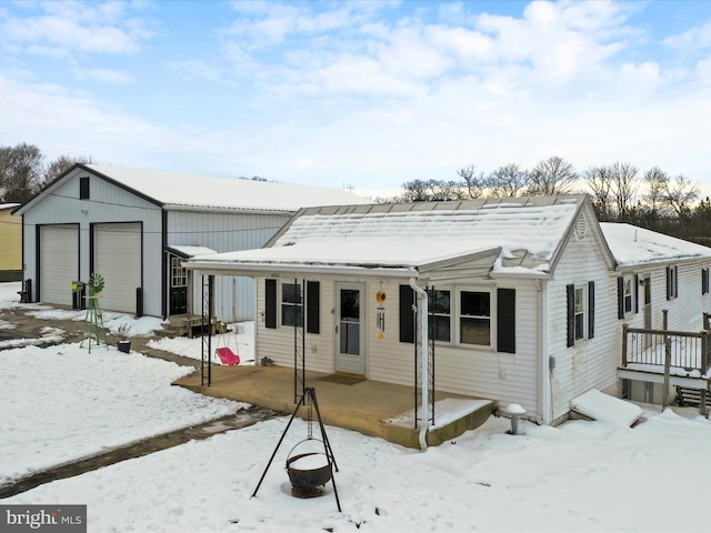 view of front of house featuring a garage and an outdoor structure