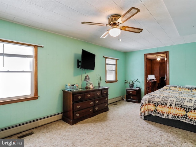 bedroom with ceiling fan, light colored carpet, and a baseboard radiator