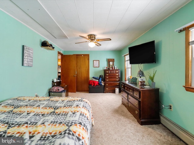 bedroom with ceiling fan, light colored carpet, and baseboard heating