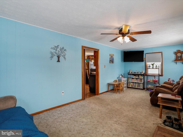 carpeted living room featuring ceiling fan and a textured ceiling