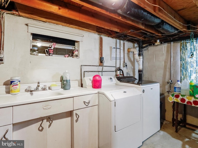 laundry area featuring washing machine and dryer and sink