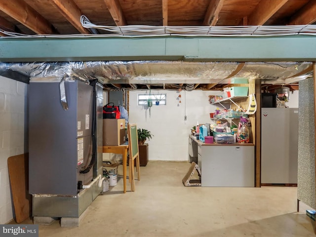 basement with stainless steel refrigerator