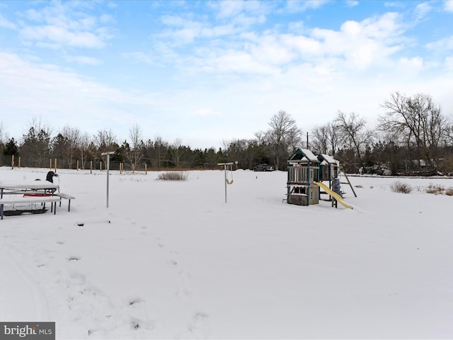 snowy yard with a playground