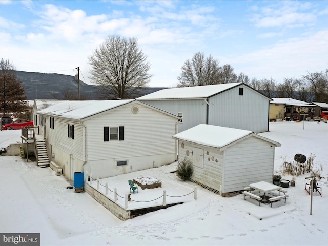 view of snow covered rear of property