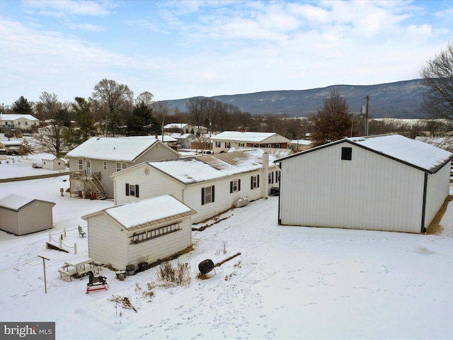 snowy aerial view featuring a mountain view