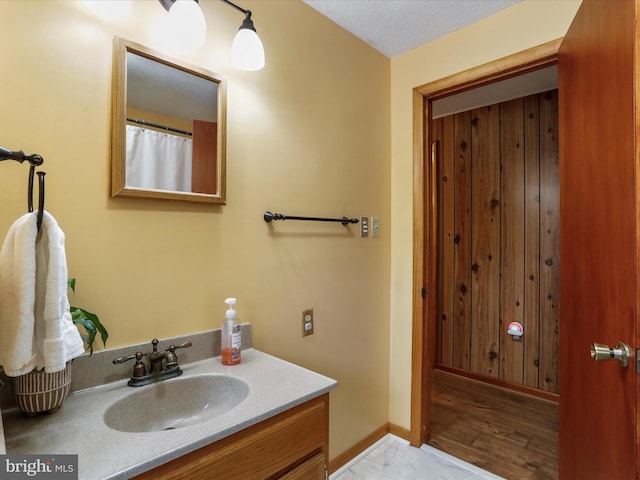 bathroom featuring a textured ceiling and vanity