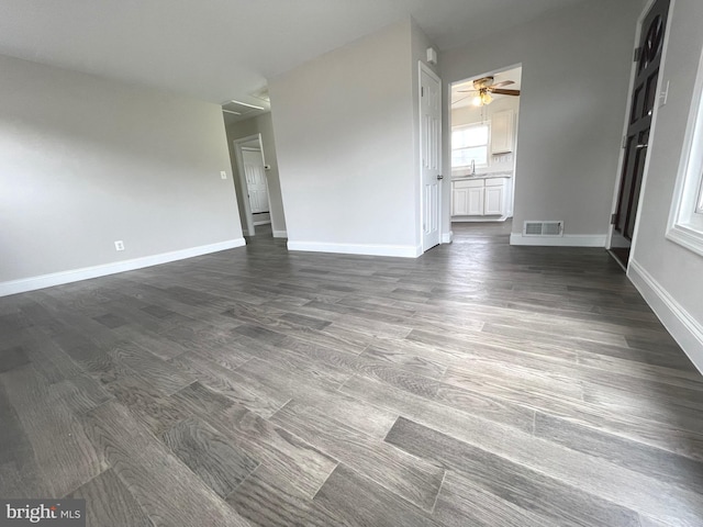 unfurnished room featuring ceiling fan and dark hardwood / wood-style floors