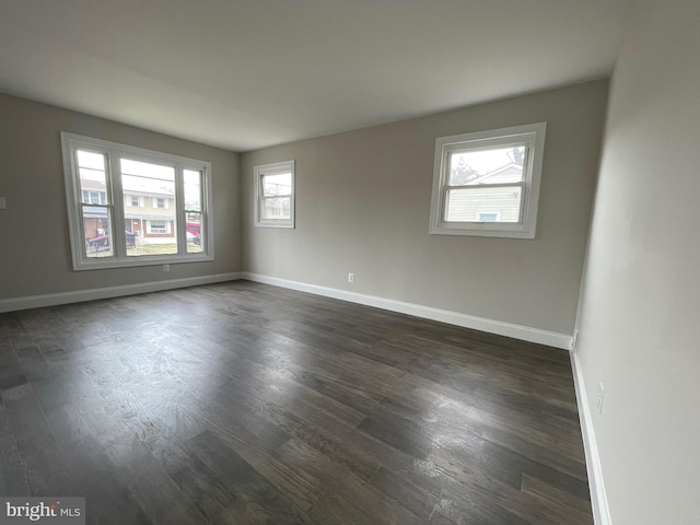 spare room featuring dark hardwood / wood-style floors