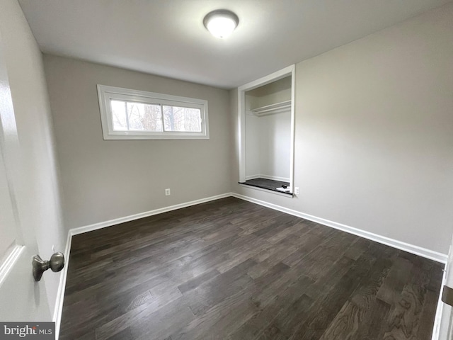 empty room featuring dark hardwood / wood-style flooring