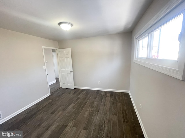 unfurnished room featuring dark hardwood / wood-style flooring