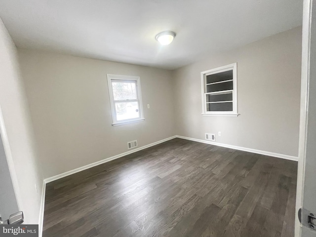 spare room with dark hardwood / wood-style flooring