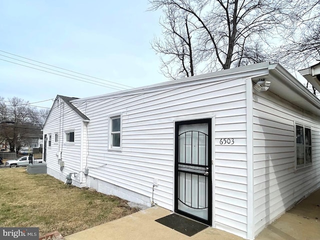 view of property exterior featuring a lawn