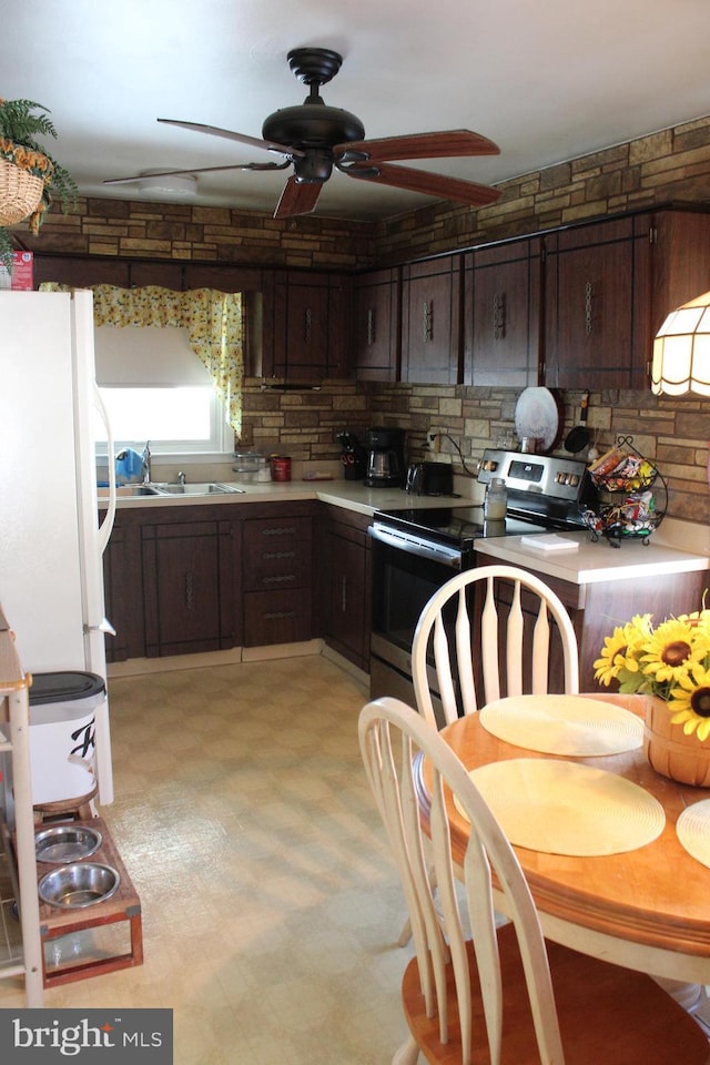 kitchen featuring white fridge, dark brown cabinets, sink, and stainless steel electric range