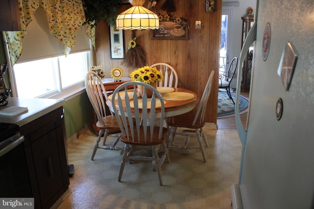 dining room featuring wooden walls