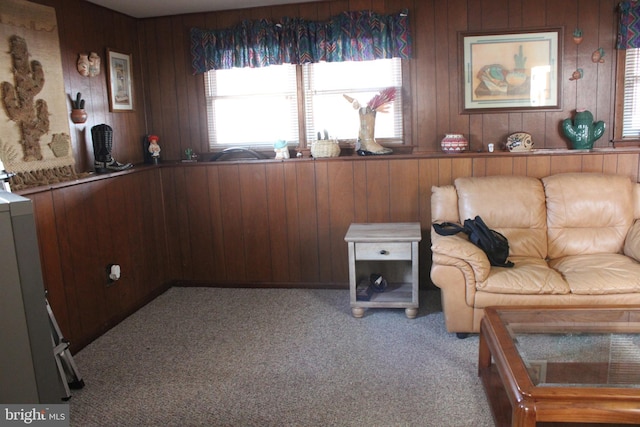 living room featuring light colored carpet and wood walls