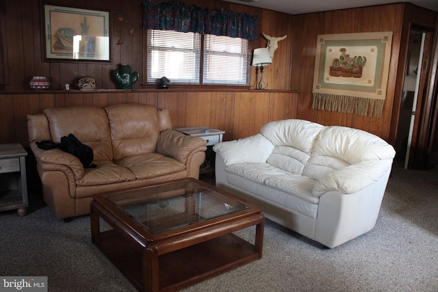 carpeted living room featuring wood walls