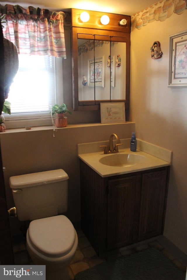 bathroom featuring vanity and toilet