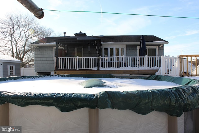 view of snow covered rear of property